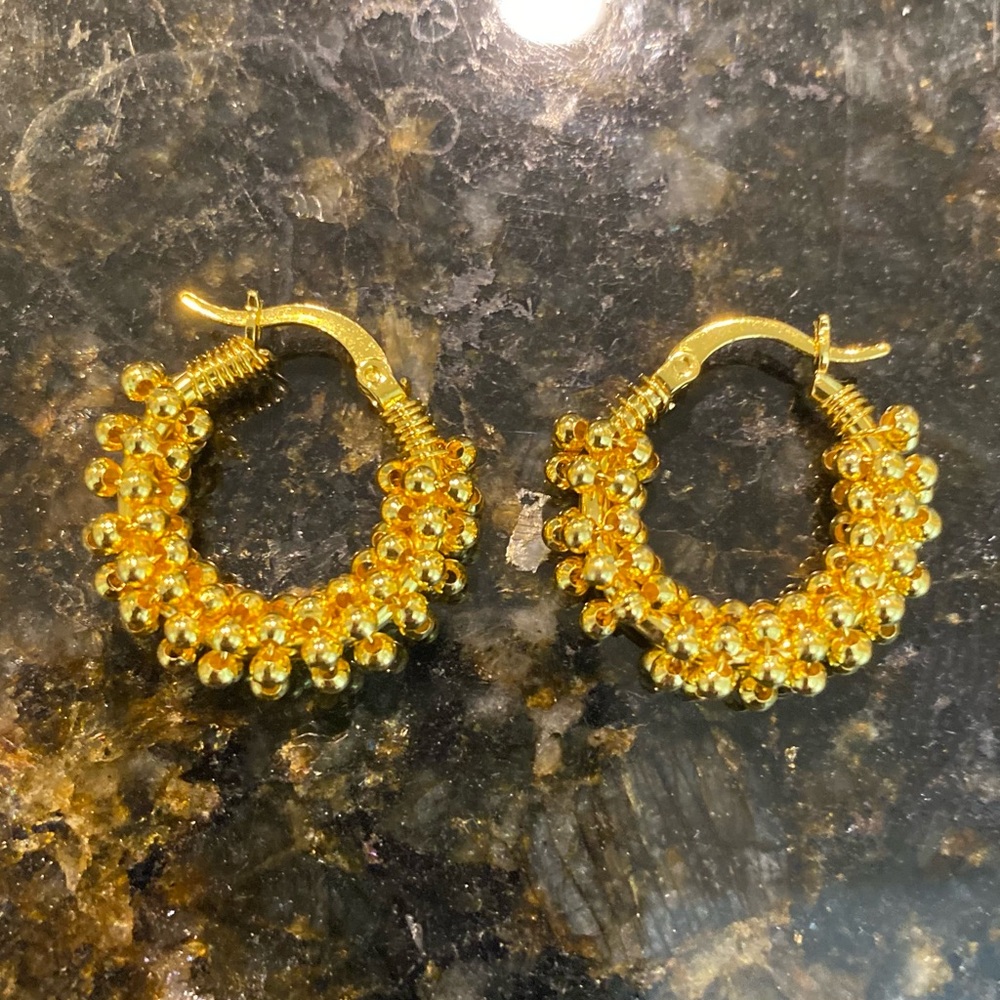 Women’s costume, gold beaded hoop earrings